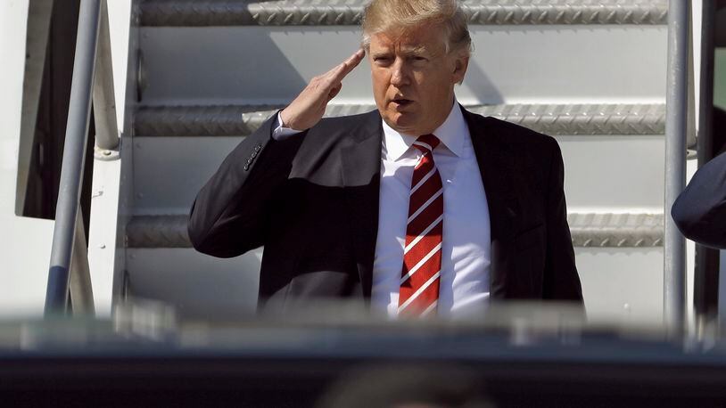 FILE - In this Monday, Feb. 6, 2017, file photo, U.S. President Donald Trump salutes as he arrives on Air Force One at MacDill Air Force Base, in Tampa, Fla. New Zealand's Prime Minister Bill English said Tuesday he told Trump during a phone call that he disagreed with his travel and refugee ban but that the conversation remained amicable. (AP Photo/Chris O'Meara/File)