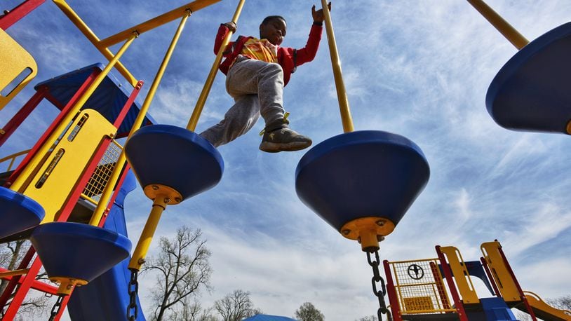Elisha Butler, 7, plays on the playground at Smith Park earlier this month. The city is asking residents to complete a parks survey in hopes of improving the park system. NICK GRAHAM / STAFF