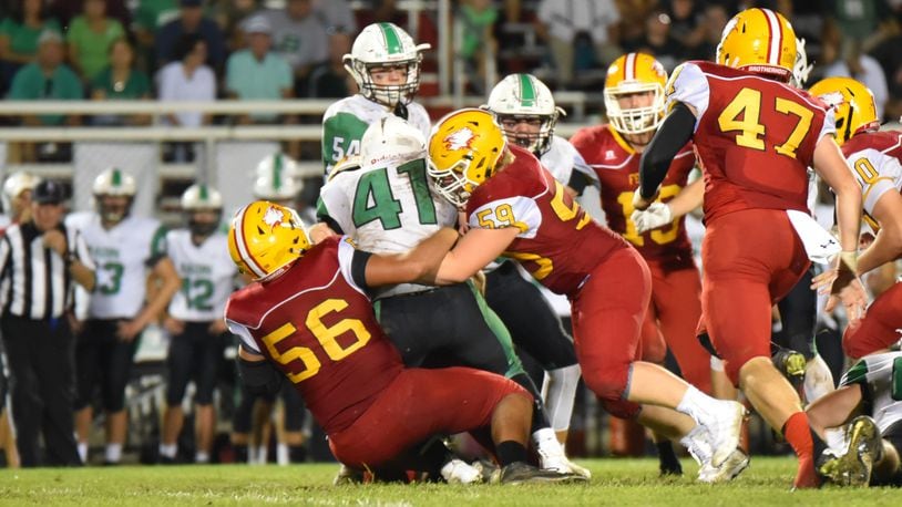 Fenwick’s Sam Secrest (56) and Leo Bell (59) bring down Badin’s Ethan Wishart (41) during last Friday’s game at Krusling Field in Middletown. Host Fenwick won 21-9. CONTRIBUTED PHOTO BY ANGIE MOHRHAUS