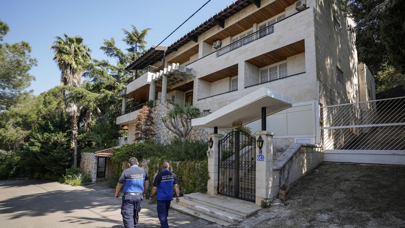 Municipal police officers patrol outside a villa where the Lebanese money changer Mohammad Srour, 57, was found tortured and killed in Monte Verdi neighbourhood of Beit Meri, Lebanon, Tuesday, April 16, 2024. The mysterious abduction and murder of a United States-sanctioned Lebanese money changer in a three-story villa on the edge of a quiet mountain resort town overlooking Beirut was most likely the work of Israeli operatives, Lebanon's interior minister said Wednesday. (AP Photo/Hassan Ammar)