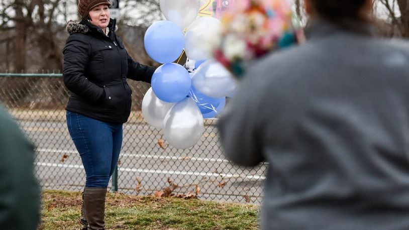 Rebecca Sandle, the mother of CJ Sandle, who was murdered in 2016, gathered with friends for a balloon launch on what would have been CJ’s 21st birthday Tuesday, Jan. 10, 2017 at Greenwood Cemetery in Hamilton. Jan. 13 marks the first anniversary of the murder of CJ Sandle in his Hamilton home. His mother, Rebecca, has taken to social media asking people to mark the day with a random act of kindness. NICK GRAHAM/STAFF