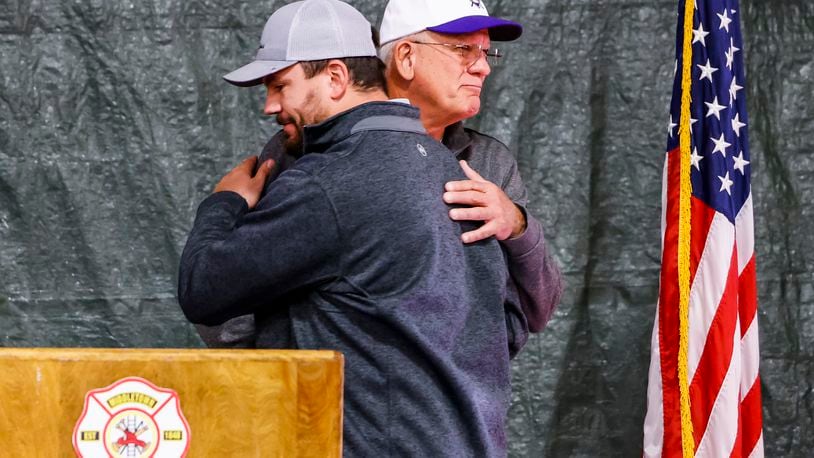 Greg Schwarber, former Middletown police chief, hugs his son Kyle Schwarber before the Middletown firefighters made a donation of more than $16,000 to Middie Way Baseball, an organization focused on helping area youth learn the game of baseball. Greg Schwarber serves as league commissioner and his son is speaking at several school assemblies about character development and teamwork. NICK GRAHAM / STAFF