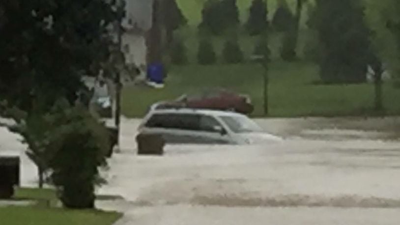 A Hamilton resident had to be rescued Wednesday night after heavy rains swept up her green Honda Odyssey on between Tabor and Cleveland avenues. CONTRIBUTED