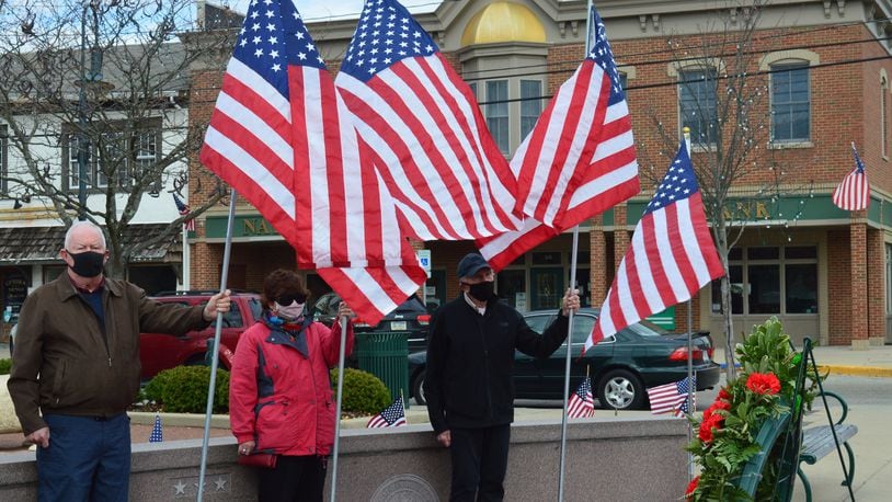 Rotary Club members were on hand Uptown holding flags in honor of the country’s veterans for the city’s Veterans Day ceremony. Three Rotarians were on either side of the memorial and the wreath, seen here at the right. CONTRIBUTED/BOB RATTERMAN