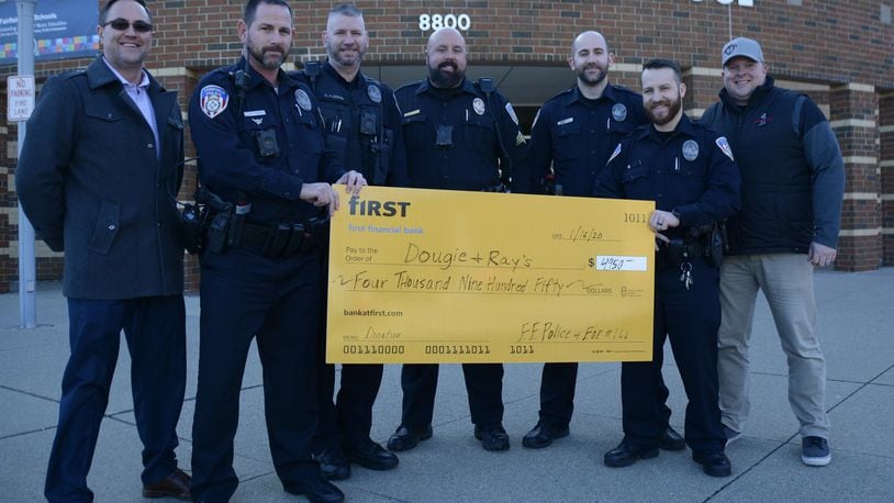 Fairfield police and the FOP Lodge 166 raised and donated $4,950 to Dougie and Ray’s, a charity that supports in-need children and families within the Fairfield School District. Pictured are Fairfield police Officers with Ted McDaniel, far right, the founder of Dougie and Ray’s, and Scott Clark, far left, a Dougie and Ray’s board member. MICHAEL D. PITMAN/STAFF