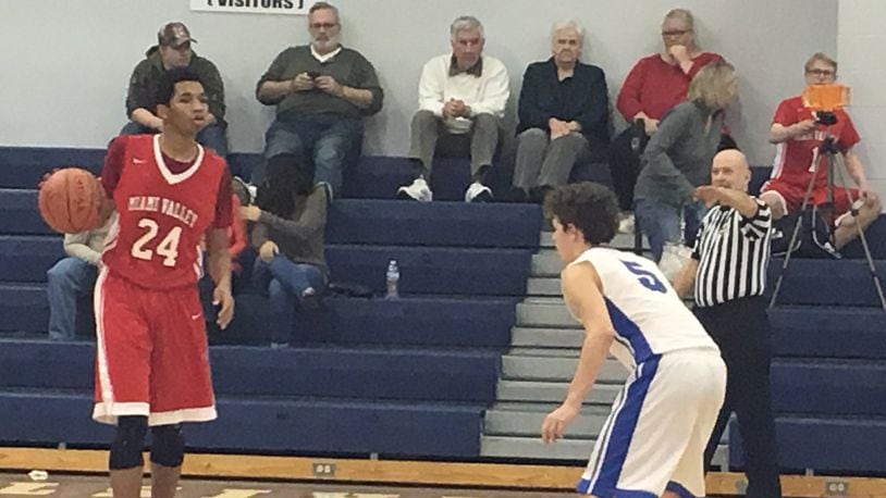Middletown Christian’s Ronin Koeller (5) keeps an eye on Miami Valley’s Marc Williams on Saturday night at MCS. RICK CASSANO/STAFF