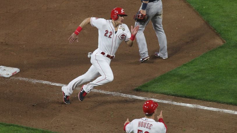 The Reds’ Derek Dietrich rounds third base and scores in the sixth inning against the Braves on Tuesday, April 23, 2019, at Great American Ball Park in Cincinnati. David Jablonski/Staff