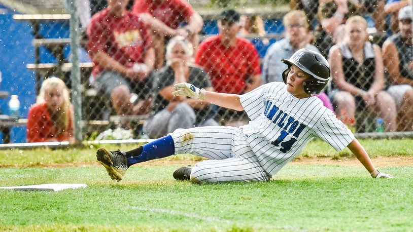 Hamilton West Side’s Nick Brosius slides safely into home plate during Tuesday night’s 10-0 victory over Hamilton-Fairfield in the winners’ bracket final of the District 9 tournament at the West Side complex. NICK GRAHAM/STAFF