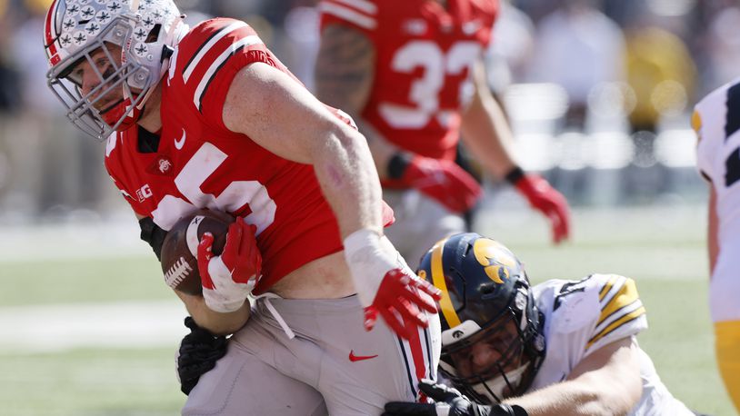 Ohio State linebacker Tommy Eichenberg, left, scores a touchdown after intercepting a pass against Iowa during the first half of an NCAA college football game Saturday, Oct. 22, 2022, in Columbus, Ohio. (AP Photo/Jay LaPrete)
