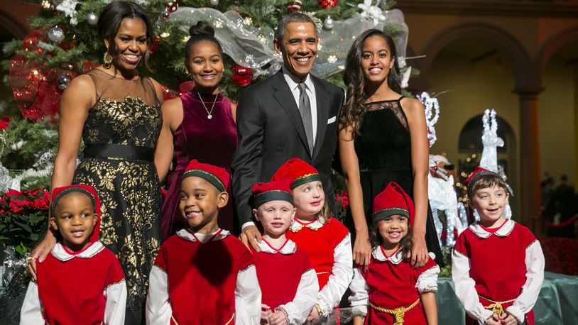 President Barack Obama, center right, first lady Michelle Obama, left, and daughters Sasha, center left, and Malia, right, pose with 'elves' prior to the taping of TNT's 'Christmas in Washington' program in Washington, D.C. on December 14, 2014. The family released their final White House Christmas cards in 2016. Photo Credit: Kristoffer Tripplaar/ Sipa USA (Photo by SIPA USA-KT/SIPA/WHITE HOUSE POOL (ISP POOL IMAGES)/Corbis/VCG via Getty Images)