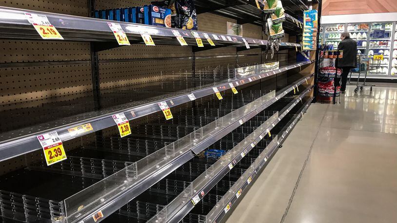 The new Kroger's Marketplace on Alex Bell was busy Monday, but there seem to be less panic buying. These pasta shelves were empty. JIM NOELKER/STAFF