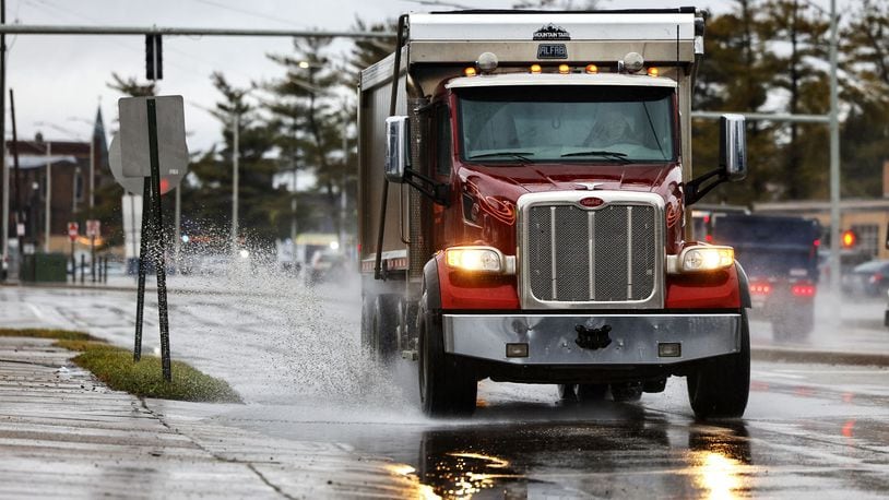 A dump truck drives through a puddle after overnight rain Tuesday morning, Jan. 9, 2024 on N. Verity Pkwy. in Middletown. NICK GRAHAM/STAFF