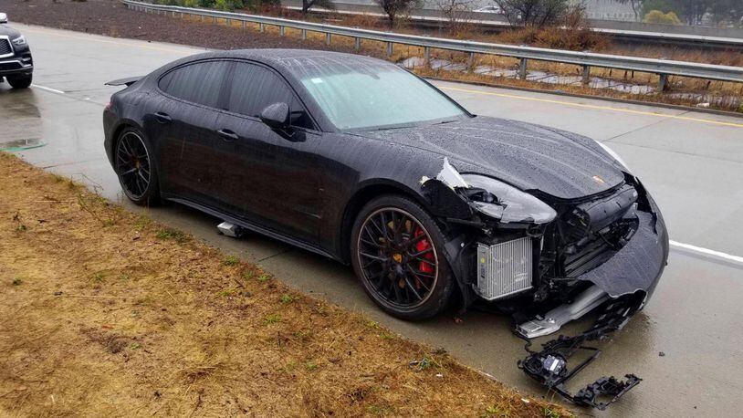 The black Porsche driven by NBA Golden State Warriors basketball star Stephen Curry was damaged after two drivers hit his car on an Oakland, Calif., freeway Friday, Nov. 23, 2018. Authorities say that, first, the driver of a Lexus lost control and struck Curry's car. After Curry stopped in the center median and waited for officers to arrive, another sedan lost control and rear-ended his Porsche.