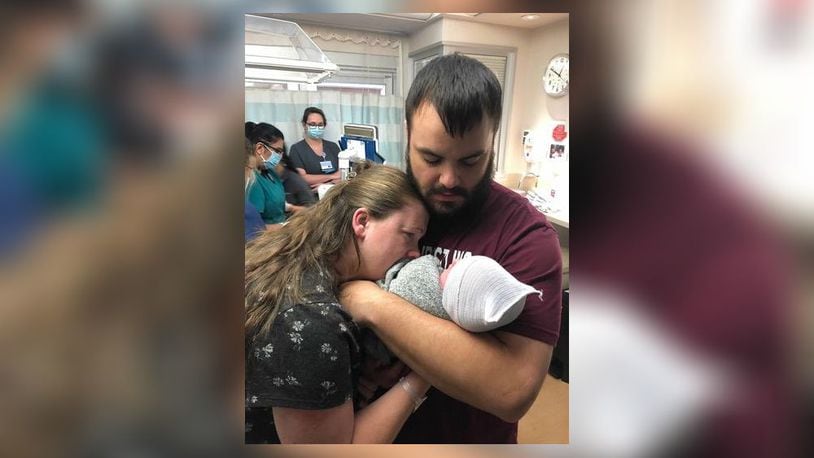 Jeremy and Liz Lovy comfort their son, Logan, after he died Sept. 15, 2021 at Miami Valley Hospital in Dayton. SUBMITTED PHOTO