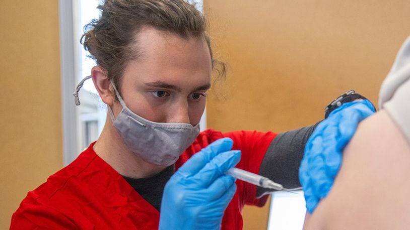 As part of a state-wide push to quickly inoculate college students against the coronavirus, Miami University has deployed its nursing students - including Mike Croy who is pictured - to help in giving the potentially life-saving injections. State officials hope to lessen the spread of the coronavirus by injecting college students and staffers prior to their departure for summer break. (Provided Photo\Journal-News)