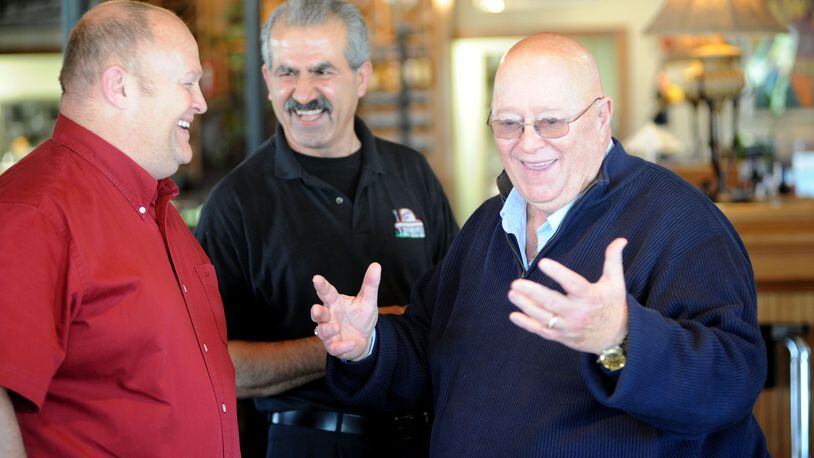 Fairfield mayor Ron D'Epifanio talks to his son Craig, left, of Fairfield Twp., after arriving at his surprise 70th birthday party at The Spinning Fork in Fairfield on Wednesday, May 4, 2011. Staff photo by Samantha Grier.