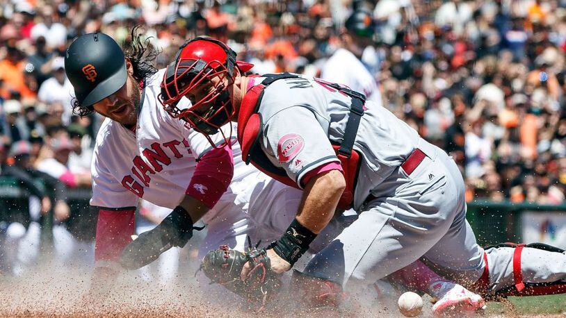 SAN FRANCISCO, CA - MAY 14: Brandon Crawford #35 of the San Francisco Giants scores a run ahead of a tag from Devin Mesoraco #39 of the Cincinnati Reds during the first inning at AT&T Park on May 14, 2017 in San Francisco, California.  Players are wearing pink to celebrate Mother's Day weekend and support breast cancer awareness. (Photo by Jason O. Watson/Getty Images)