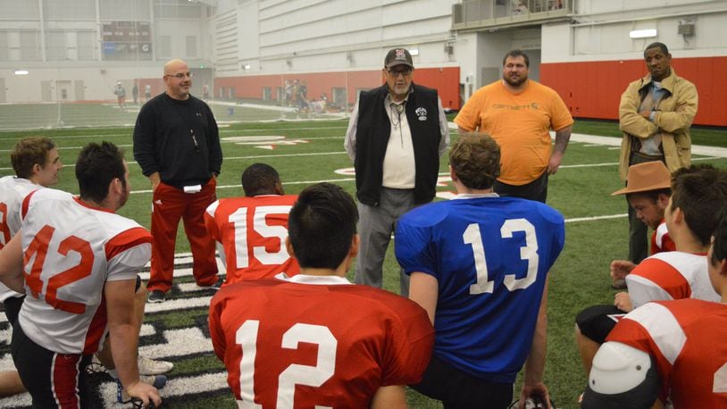 Coach Jay Fry (cap and vest) talks to his club football team after practice in preparation for their final regular-season game, a 39-16 win over Ohio State. CONTRIBUTED/BOB RATTERMAN
