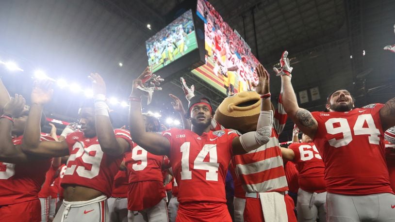 Ohio State players, including K.J. Hill (14) sing “Carmen Ohio” after a victory against Southern California on Friday, Dec. 29, 2017, at AT&T Stadium in Arlington, Texas. David Jablonski/Staff
