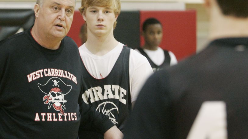 Dan Gerhard (left) is shown in this photo in 2011, when he was head coach of the West Carrollton boys basketball team, a title he held for more than 25 years. FILE PHOTO