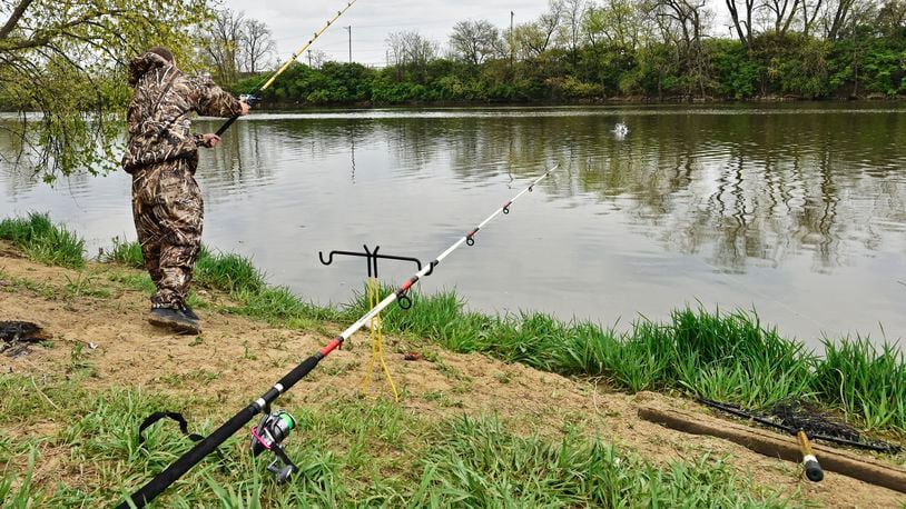 Nick Griffith fishes last April along the bank of the Great Miami River at Combs Park in Hamilton. STAFF FILE PHOTO/2016