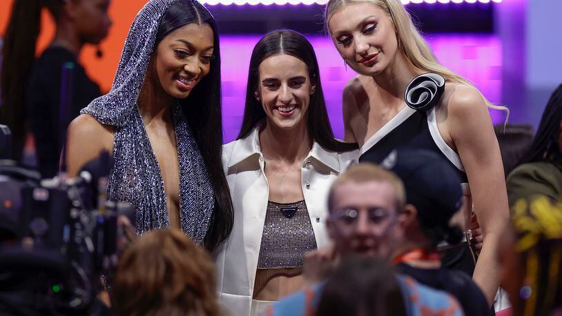 From left, LSU's Angel Reese, Iowa's Caitlyn Clark, and Stanford's Cameron Brink, pose for a photo before the start of the WNBA basketball draft, Monday, April 15, 2024, in New York. (AP Photo/Adam Hunger)