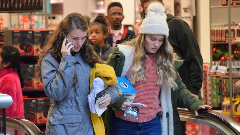 Jill Kelly, 21 of Germantown, shops with her 18-year-old sister Jessica at JCPenney when it opened at 2 p.m. Thursday. The two prefer to shop in store over online, but will look for a good deal today. STAFF PHOTO / HOLLY SHIVELY