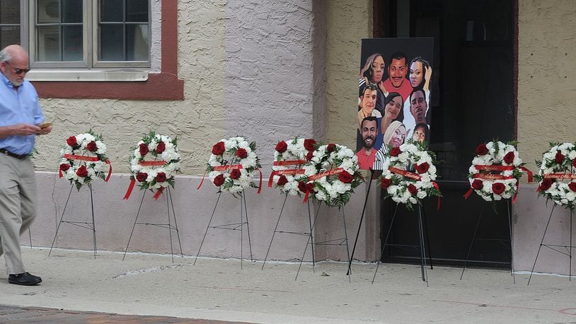 A painting of the nine victims of the Oregon District shooting, is on display in the Oregon District, Thursday Aug. 4, 2022. MARSHALL GORBY\STAFF