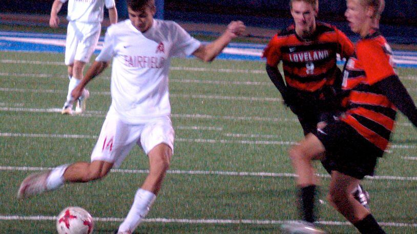 Fairfield’s Evan Van Rheenen makes a pass as two Loveland defenders move in Tuesday night during a Division I sectional final at Hamilton’s Virgil Schwarm Stadium. Loveland advanced with a 3-0 win. CONTRIBUTED PHOTO BY JOHN CUMMINGS
