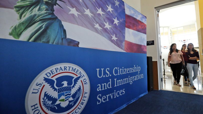 FILE - People arrive before the start of a naturalization ceremony at the U.S. Citizenship and Immigration Services Miami Field Office in Miami, Aug. 17, 2018. Authorities say lottery bids for highly-educated worker visas plunged nearly 40% this year, claiming success against people who were "gaming the system" by submitting multiple, sometimes dubious, applications to unfairly increase their chances. (AP Photo/Wilfredo Lee, File)