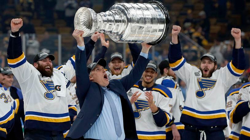 St. Louis Blues head coach Craig Berube carries the Stanley Cup after the Blues defeated the Boston Bruins in Game 7 of the NHL Stanley Cup Final, Wednesday, June 12, 2019, in Boston. (AP Photo/Michael Dwyer)