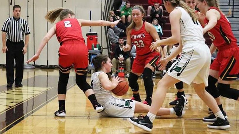 Badin’s Jaelynn Scowden (5) finds herself surrounded by Fenwick’s Hannah Tebbe (2), Brooke Brunner (23), Emily Adams and Rachel Tebbe (10) during Tuesday night’s Division II sectional game at Lebanon. Fenwick won 53-46. CONTRIBUTED PHOTO BY TERRI ADAMS
