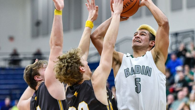 Badin’s Daunte DeCello puts up a shot over Alter’s Connor Meyer (4) and Derek Willits (23) during their Division II sectional semifinal Tuesday night at Fairmont’s Trent Arena. NICK GRAHAM/STAFF