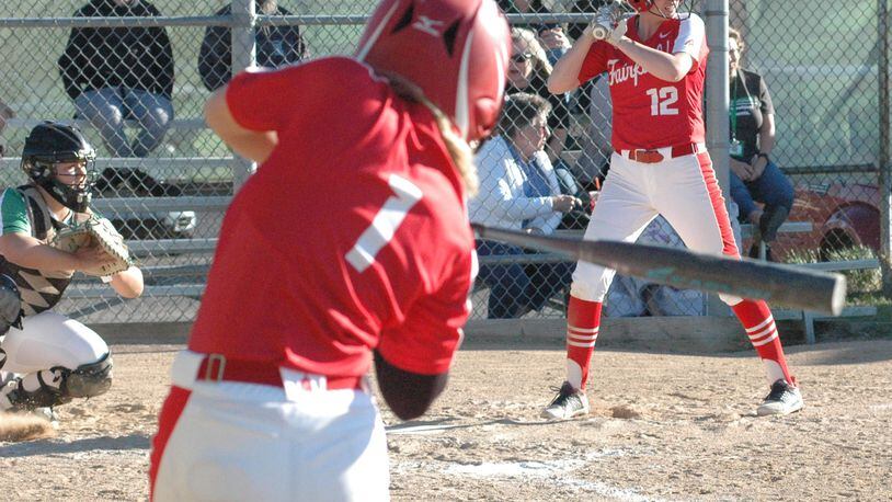 Fairfield High School's Maiah Hodge (1) takes a warmup swing while teammate Lindsey Mitchell (12) stands in at the plate Tuesday, April 9, during a nonconference softball game at Harrison. The host Wildcats won 2-1. RICK CASSANO/STAFF