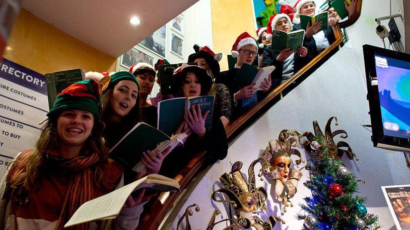 St Peter's College Oxford sing carols in Angels fancy dress shop to raise money to support the Crisis homeless persons charity on December 18, 2015 in London, England. The mixed-voice choir made of students from the college sing during the weekly Evensong services during term time.  (Photo by Ben Pruchnie/Getty Images)