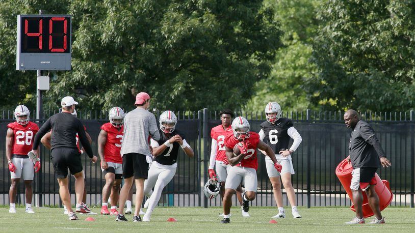 TreVeyon Henderson carries the ball after a handoff from C.J. Stroud at the first Ohio State practice of the season on Thursday, Aug. 4, 2022, at the Woody Hayes Athletic Center in Columbus. David Jablonski/Staff