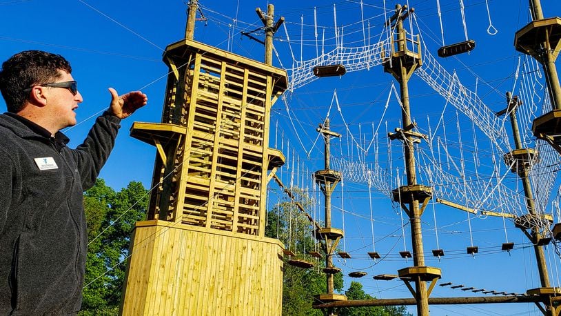 Pete Fasano, executive director of Camp Campbell Gard, shows off the at the Great Miami Valley YMCA's high ropes course now open at Camp Campbell Gard Wednesday, May 15, 2019 on Augspurger Road in St. Clair Township. The course stands nearly fifty feet tall with three levels of elements ranging in difficulty. There is also a climbing wall, zip line, giant swing and more. The course has a universal access system allowing participants with all abilities, including those in wheel chairs, the opportunity to experience it. NICK GRAHAM/STAFF