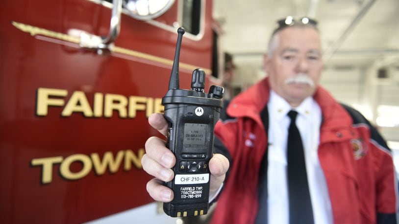 Fairfield Township Fire Chief Tim Thomas holds one of the Motorola radios the department bought last year. Other departments in the county were hoping for a $2 million FEMA grant to get new radios but the application was denied. NICK GRAHAM / STAFF