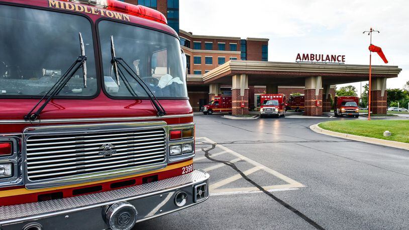 Four medic units and a fire engine from Middletown Division of Fire are parked at the emergency room entrance at Atrium Medical Center after the there were four emergency calls in the city within minutes Monday, June 26. NICK GRAHAM/STAFF
