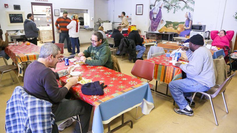 In this 2016 file photo, residents eat lunch at the Chosen homeless shelter at Serve City in Hamilton. GREG LYNCH / STAFF