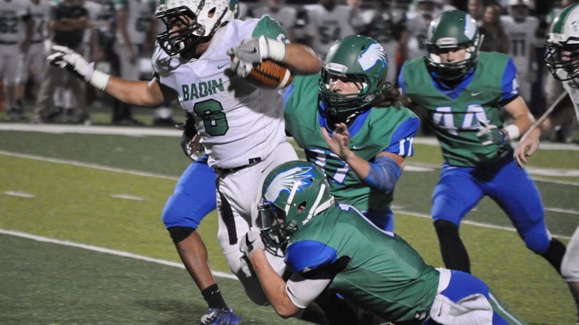 Badin’s Lavassa Martin (6) is brought down by Chaminade Julienne’s Brendan Kadel (7) during Friday night’s game at Roger Glass Stadium in Dayton. CONTRIBUTED PHOTO BY NICK DUDUKOVICH