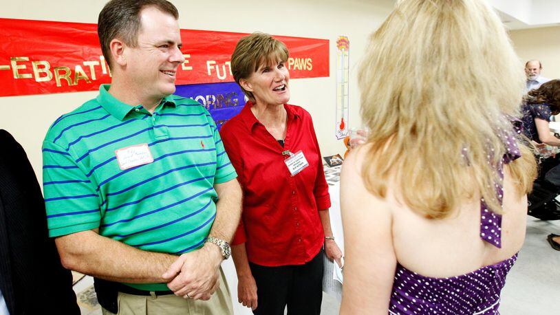 Mike Gigis (left), co-owner of the West Chester Veterinary Center, socializes with PAWS board of directors president Sue Hutson (center) and Juli Nimitz, director of the PAWS capital campaign, during a VIP event held Thursday, Aug. 7, at their new facility on Crossings Blvd. in Monroe.