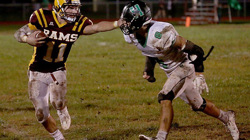 Ross quarterback Zach Arno tries to avoid Harrison defensive back Bailey Smith during their game at Ross on Sept. 16. CONTRIBUTED PHOTO BY E.L. HUBBARD