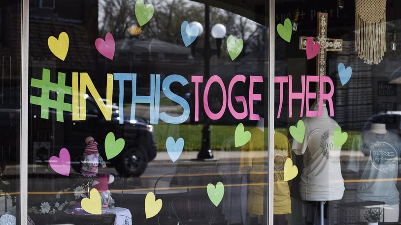 Scattering Joy Craft Boutique on Main Street in Hamilton is one of the businesses concerned the city government plans to buy their building for another development, forcing them to move elsewhere. In April of 2020, the business put hearts on its windows like many businesses in Butler County showing support for the community during the coronavirus pandemic. One way the business survived the pandemic was by making masks to protect people from COVID-19. NICK GRAHAM/STAFF