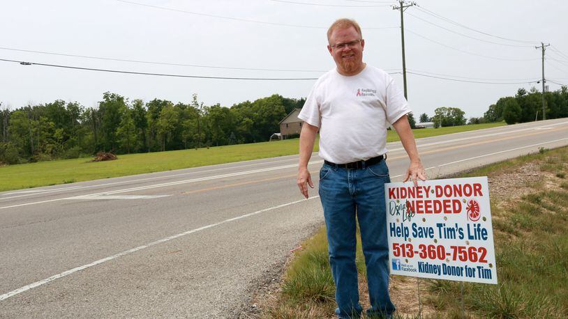 Monroe resident Tim Gentile with one of the signs advertising his search for a kidney donor. EMMA STIEFEL/STAFF