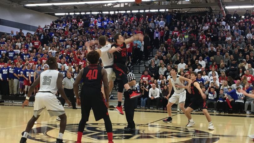 Lakota West’s Mitch Wagner winning the opening tipoff against Lakota East’s Alex Mangold in front of a packed crowd at the Hawks Nest. East won 58-48. Laurel Pfahler/CONTRIBUTED