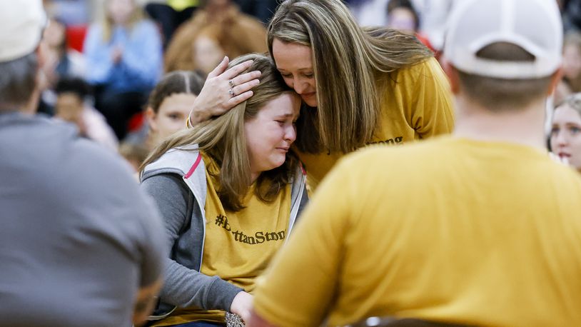 Bryttan Cain, 13, who has been battling brain cancer, was surround by friends and family at Crossroads Middle School Thursday, March 23, 2023 when she was surprised with the announcement she and her family would get to go to Disney World through Make-A-Wish Foundation. Her mom, Amanda Fiorini, hugs her after the surprise. NICK GRAHAM/STAFF