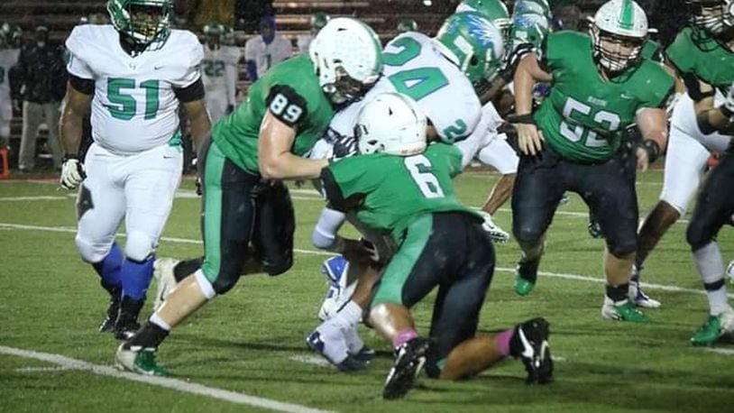 Badin’s Grayson Taylor (89) and Jayden Carter (6) bring down Chaminade Julienne running back Quincy Johnson (24) on Friday night at Fairfield Stadium in Fairfield. Badin took a 38-21 victory. CONTRIBUTED PHOTO BY TERRI ADAMS
