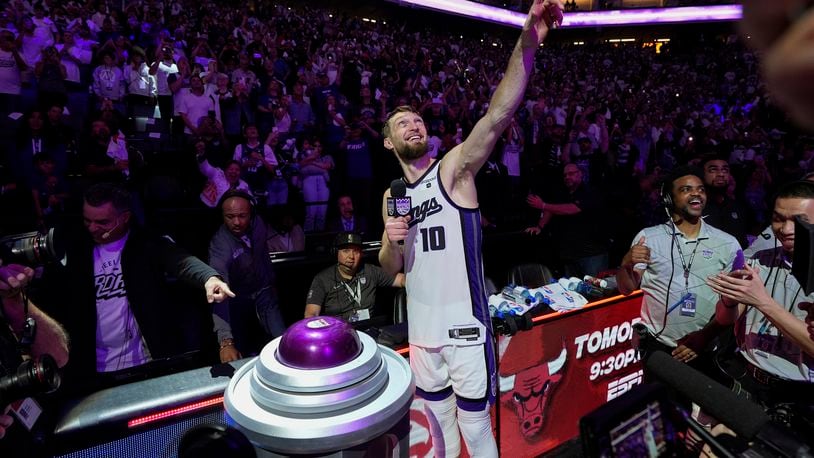 Sacramento Kings forward Domantas Sabonis (10) lights the beam after the team's victory over the Golden State Warriors in an NBA basketball play-in tournament game Tuesday, April 16, 2024, in Sacramento, Calif. (AP Photo/Godofredo A. Vásquez)