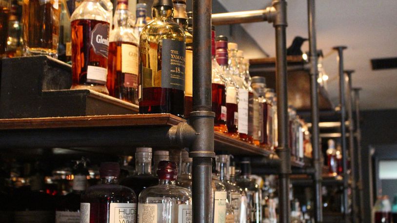 The back bar at Swift’s Attic carries more than 100 different whiskeys, ranging from bourbon to Japanese whisky to Scotch and more.
